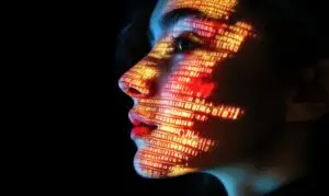 Face with coding running over it. Black background and orange code.